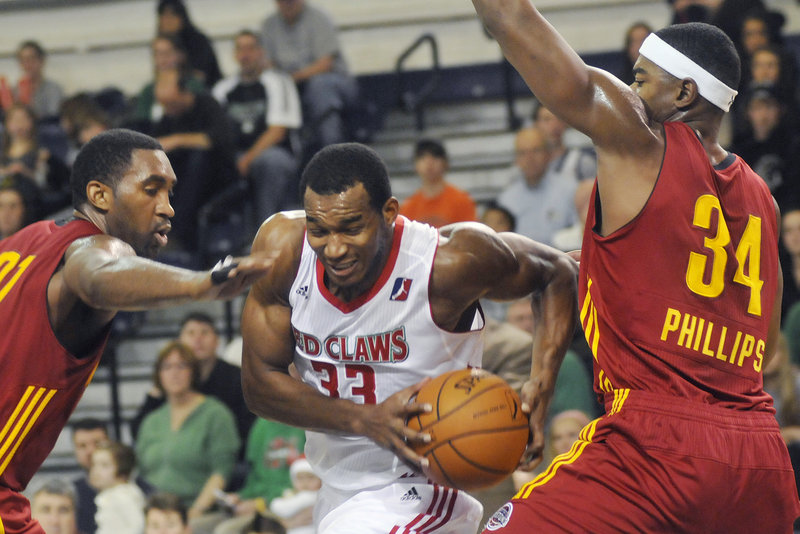 Chris Wright of the Maine Red Claws drives to the basket as Fort Wayne's Darnell Lazare and Marvin Phillips defend in Sunday's game at the Portland Expo.