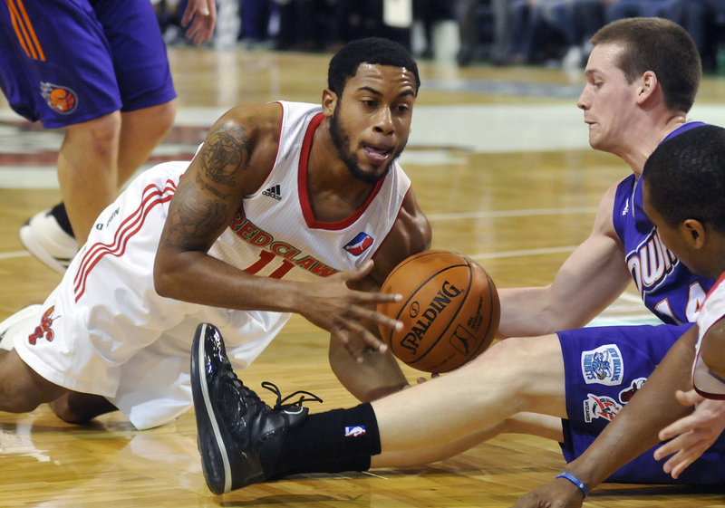 Courtney Pigram of the Maine Red Claws goes to the floor for a loose ball in front of Thomas Baudinet of the Iowa Energy during Maine’s 101-86 win Saturday.