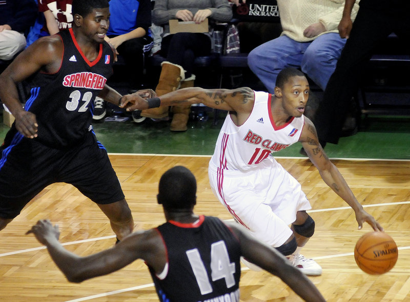 Kenny Hayes of the Red Claws looks for an opening in Springfield’s defense during Sunday’s game at the Portland Expo. Maine lost to the Armor for the fourth time in five meetings this season.