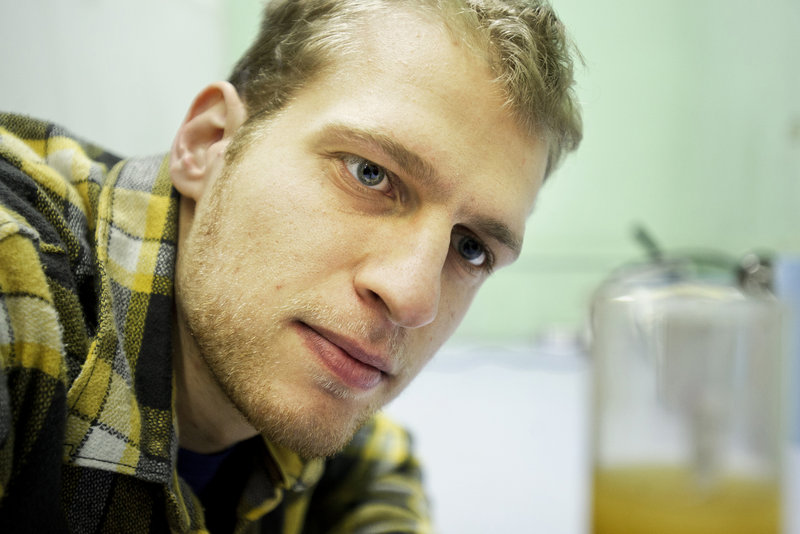 Ross Brockman checks the sugar content of a cider sample.