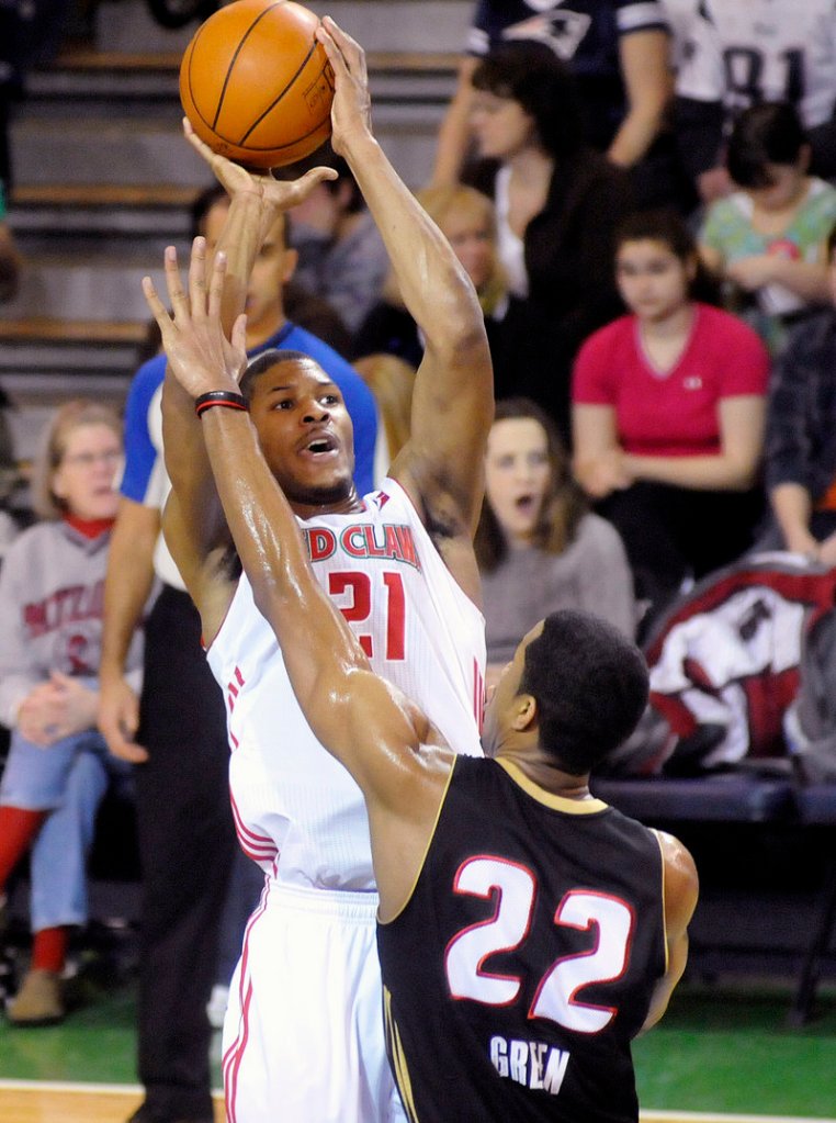 Morris Almond takes a shot over Erie’s Devin Green in Sunday’s game at the Portland Expo. Almond had 27 points in Maine’s 110-88 win.