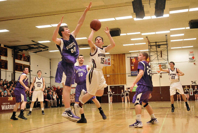 Photo by Michael G. Seamans Game action from Eastern Class B boys playoff game at Nokomis High School in Newport Wednesday night. Nokomis defeated Waterville 50-49 in overtime..