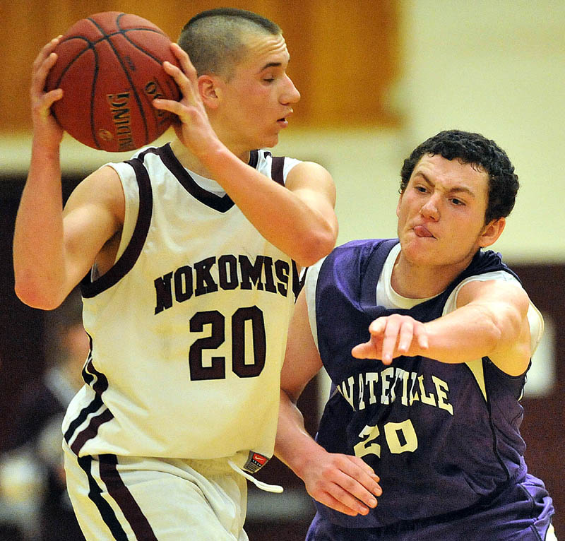 Photo by Michael G. Seamans Game action from Eastern Class B boys playoff game at Nokomis High School in Newport Wednesday night. Nokomis defeated Waterville 50-49 in overtime..