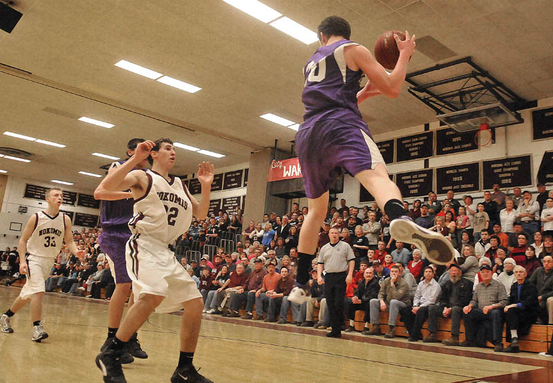 Photo by Michael G. Seamans Game action from Eastern Class B boys playoff game at Nokomis High School in Newport Wednesday night. Nokomis defeated Waterville 50-49 in overtime..