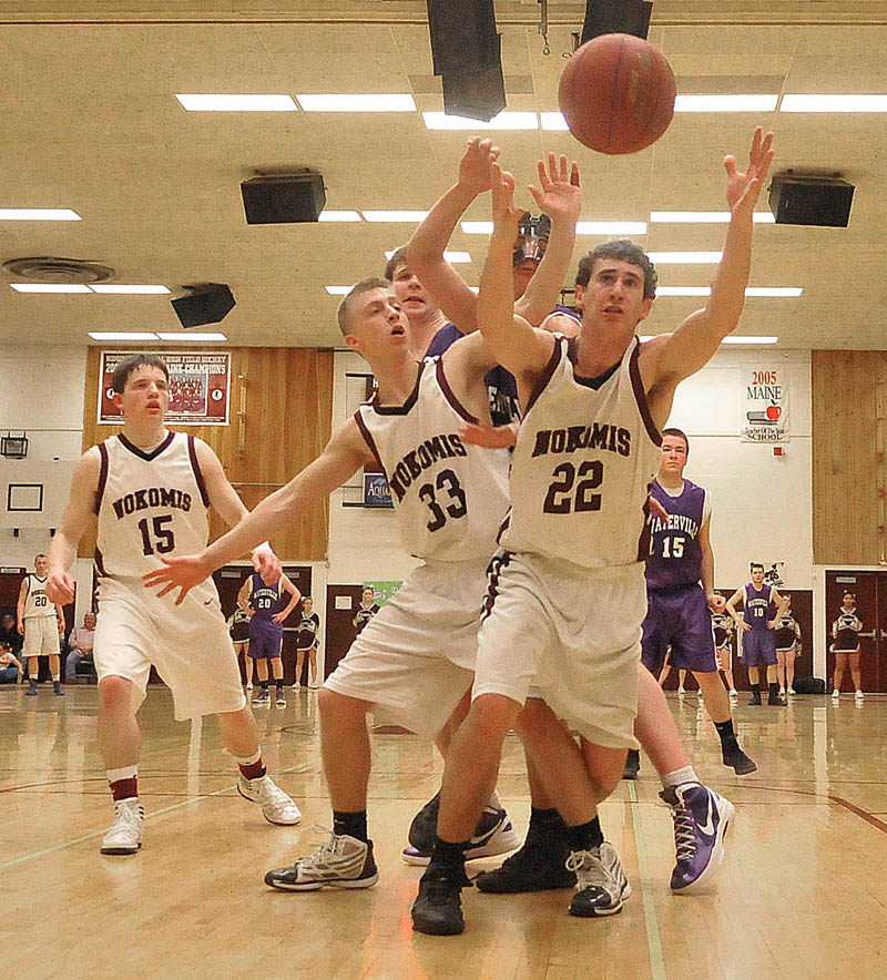 Photo by Michael G. Seamans Game action from Eastern Class B boys playoff game at Nokomis High School in Newport Wednesday night. Nokomis defeated Waterville 50-49 in overtime..