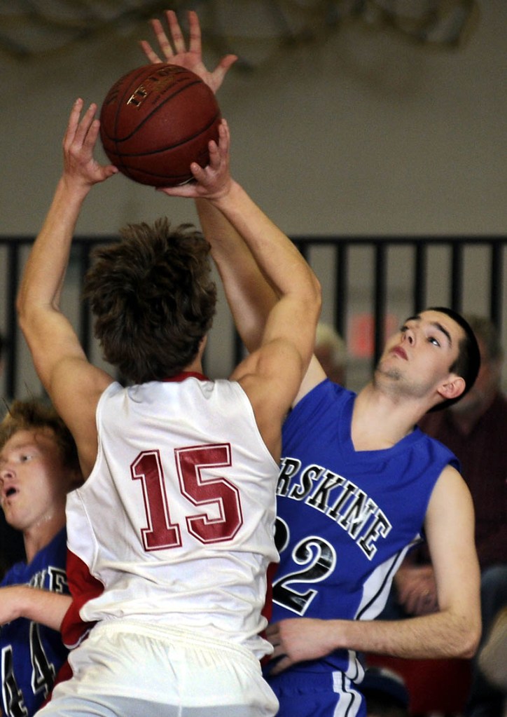 BLOCK SHOT: Erskine Academy’s Shyler Scates, right, blocks Cony High School’s Josiah Hayward Wednesday during a basketball match up in Augusta. At left is Erskine’s Tyler Belanger.