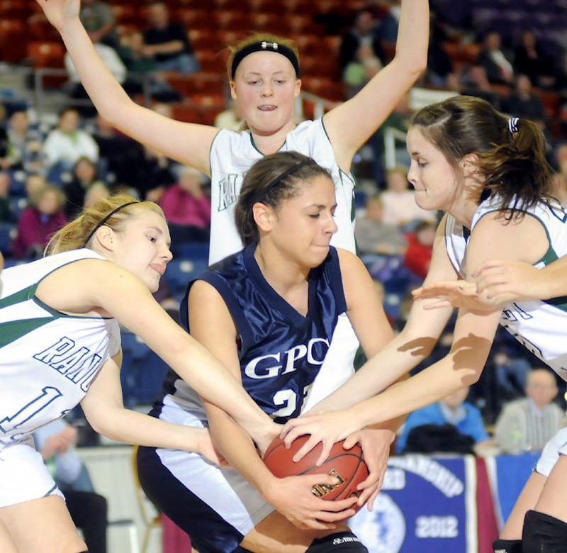 FULL PRESS: Rangeley Lakes Regional School's Seve Deraos, left, Taylor Esty, center, and Emily Carrier block Greater Portland Christian School's Suzane Gonzalez during a Class D match up Monday in Augusta.