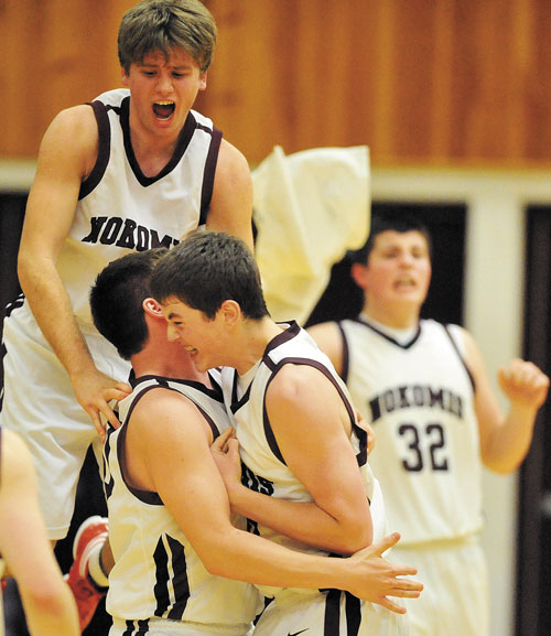 JUMP FOR JOY: Nokomis teammates Caleb Littlefield, back left, Devan Haas, bottom left, and Andrew Cartwright celebrate after defeating Waterville 50-49 in overtime Wednesday in Newport.