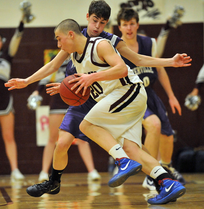 TO THE HOOP: Nokomis’ Spencer Hartsgrove, right, drives on Waterville’s Jordan Derosby in the second quarter Wednesday at Nokomis Regional High School in Newport. Nokomis defeated Waterville 50-49 in overtime.