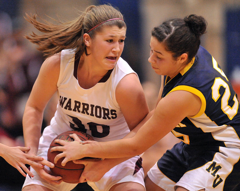 Anna Mackenzie, left, of Nokomis, and Amanda Hendrickson-Belloguet of Medomak Valley battle during Saturday’s Eastern Class B quarterfinal, a 58-51 Nokomis win.