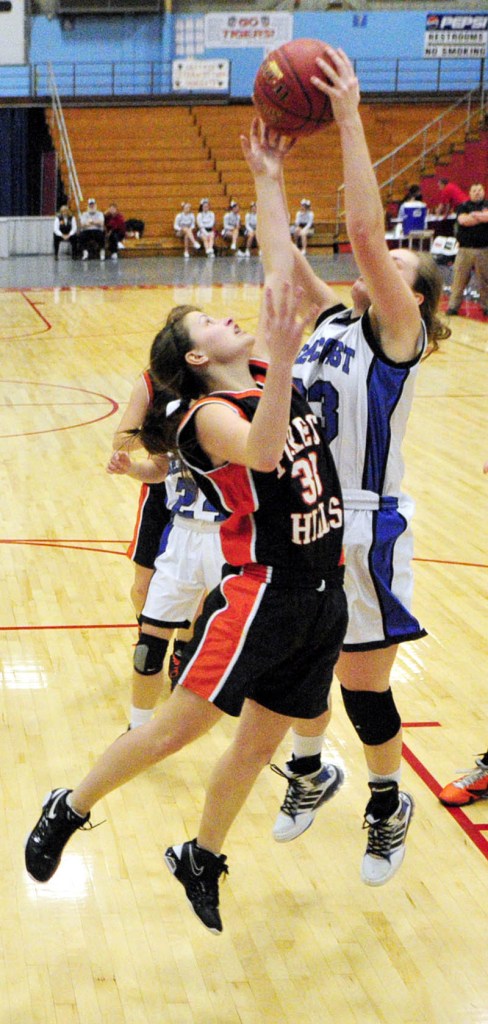 Ruth Towne, right, of Seacoast Christian gets her hands on a rebound ahead of Haley Cuddy of Forest Hills. Seacoast Christian won the Western Class D quarterfinal, 60-34.