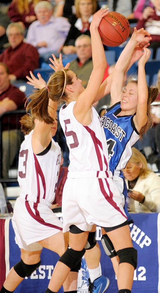 Jenny English, right, of Seacoast Christian finds herself hemmed in by Morgan Harrington, left, and Jamie Plummer during Richmond’s 54-28 victory.