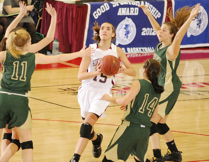 Jamie Plummer, center, scored 21 points, grabbed 13 rebounds and blocked five shots as Richmond beat Rangeley 46-33 to win their second straight regional title.