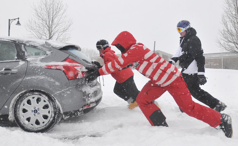 From left, Thornton Academy students Alex Lambert, Drew Gelinas and Jeff Gelinas help a stranded driver on what turned out to be a snow day in Saco and many other communities Thursday.