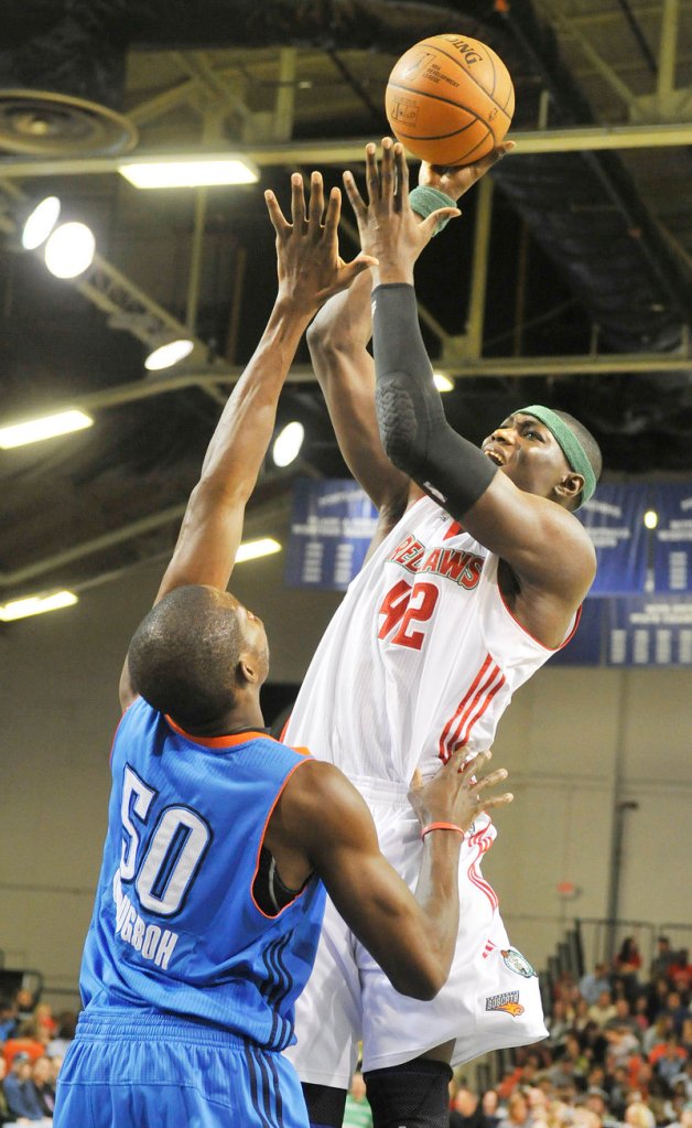 Hamady Ndiaye of the Maine Red Claws lofts a shot Friday night over Nkem Ojougboh of the Tulsa 66ers during Maine’s 100-99 victory at the Portland Expo.