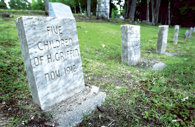 Stones mark the graves of island residents whose bodies were dug up and reburied at what became Pineland Farms in New Gloucester. Jack Milton