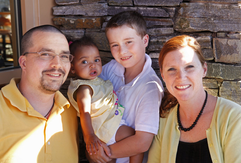 Derek Hayes, left, stands last week with his kids – 9-month-old Shiloh being held by 9-year-old Parker – and his wife, Rebecca. The Sanford man says his family has helped him to make better life decisions.