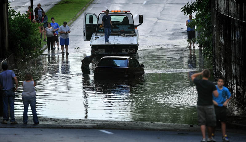 A car on upper Main Street in Fairfield is towed away Friday evening after a fast moving storm blew through the area.