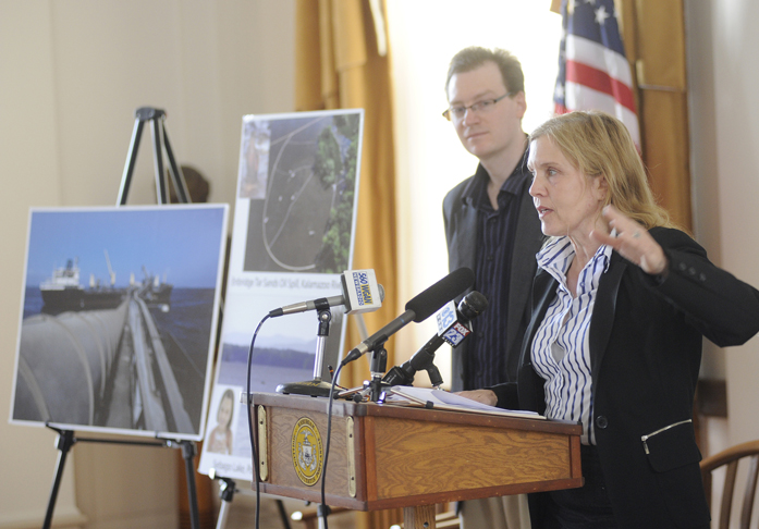 Shelley Kath of the National Resource Defense Council speaks at a news conference at City Hall in Portland today. The council released a report that details threats of a proposed pipeline that would bring tar sands oil from Canada to Maine.