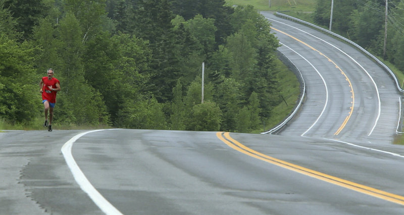 Jon Aretakis runs along Route 1 in Perry on June 9 as part of the 100-mile sacred run relay organized by members of the Passamaquoddy Tribe to call attention to a blocked fishway on the St. Croix River preventing alewives from reaching their spawning habitat. The tribe’s three chiefs later declared a “state of emergency,” calling on the state to remove the blockage.