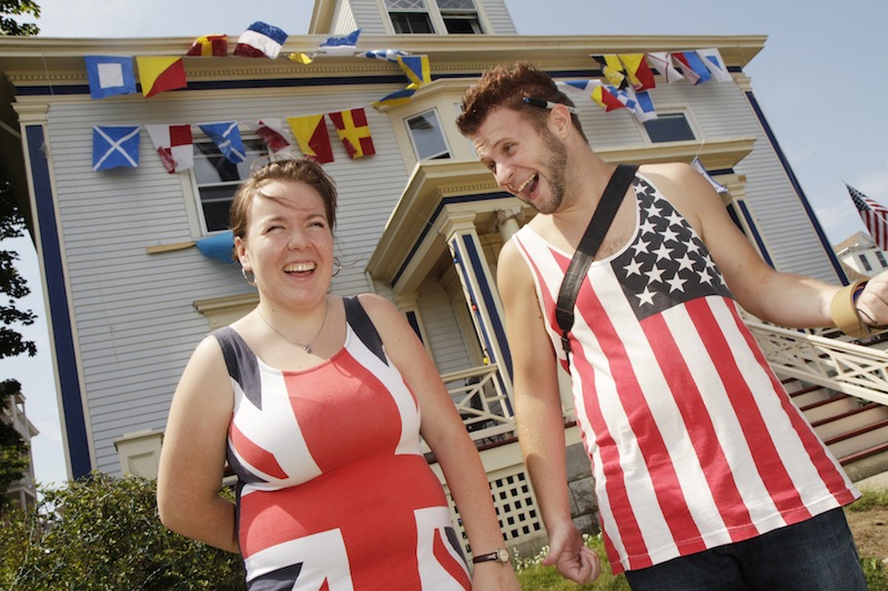 Carl D. Walsh/Staff Photographer: Madeleine Paine and Jake Hancock, dressed in flags, stand in front of Paine's 150 Eastern Promanade Ave home decorated for a Mumford & Sons concert on Saturday August 4, 2012. The prize for the best decorated home, reportedly is a personal appearance by the Mumford and Sons band in the winner's livingroom.