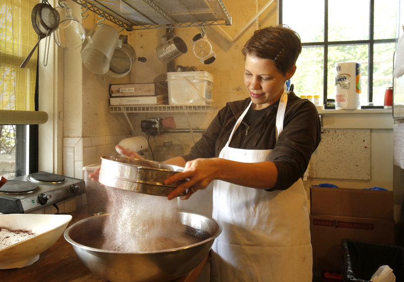 Tara Smith sifts flour into a brownie mixture at Standard Baking Co. in Portland. “Standard Baking Co. Pastries” by Smith and Alison Pray is due out on Oct. 15. The book features many of Standard Baking’s most popular items with photography by Sean Alonzo Harris.