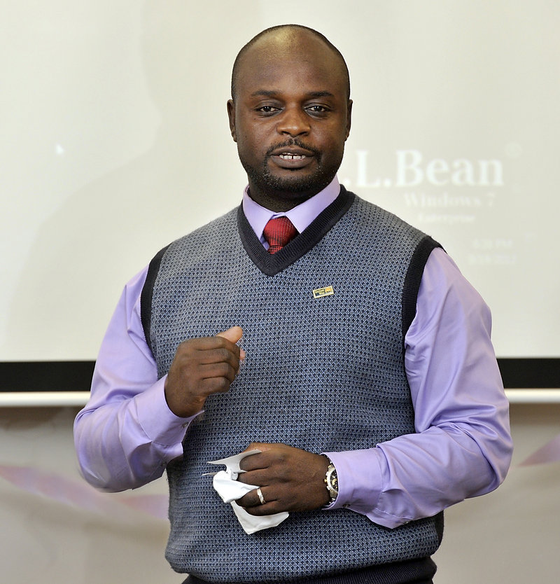 Maxwell Chikuta, who volunteers as a member of the United Way speakers bureau, addresses a rally at the L.L. Bean Order Fulfillment Center in Freeport on Wednesday.