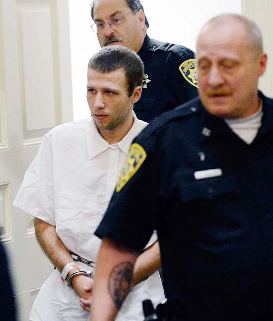 Derek Poulin, who is charged with arson and murdering his grandmother, Patricia Noel, is led into York County Superior Court in Alfred on Tuesday.