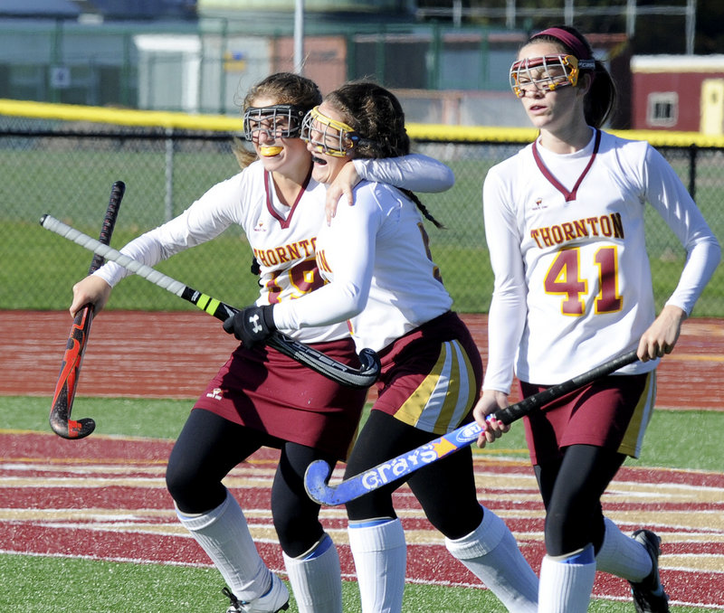 Carli Legere, center, is hugged by Francesca Petrucci after scoring the first goal Saturday for Thornton Academy in a 2-0 win over Bonny Eagle. At right is Lauren Russell.