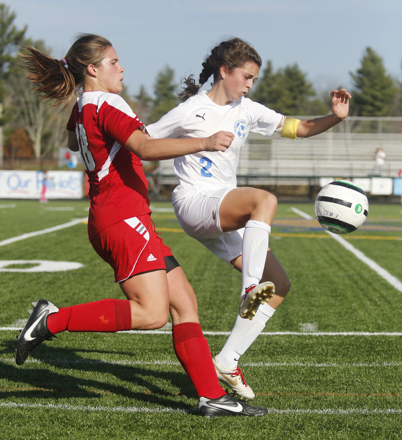 Caitlin Bucksbaum of Falmouth tries to move forward with the ball as Maria Valente of Gray-New Gloucester plays tight defense during a Western Class B semifinal. Falmouth won, 2-1, and will play No. 1 Morse for the regional title.