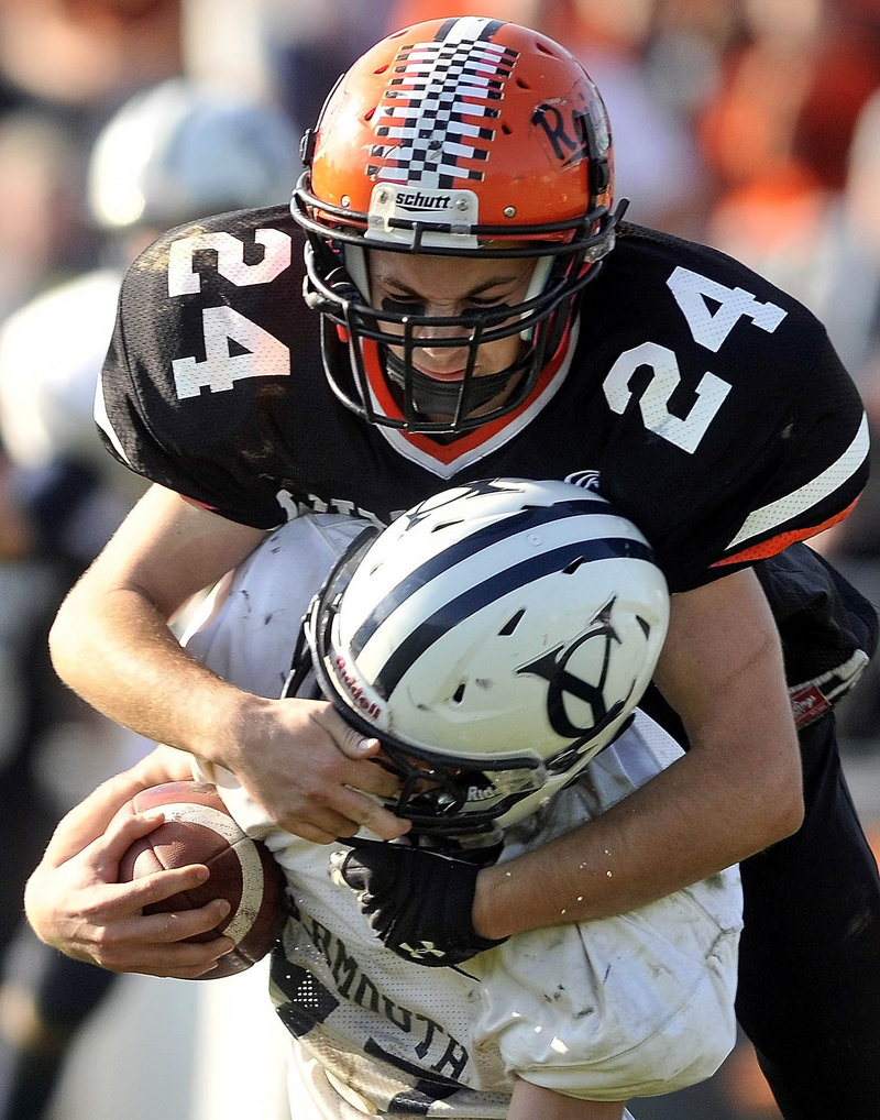 Matthew Fortier of Winslow takes down Yarmouth’s Race Morrison, during the Black Raiders’ 50-22 win in the Western C quarterfinals.