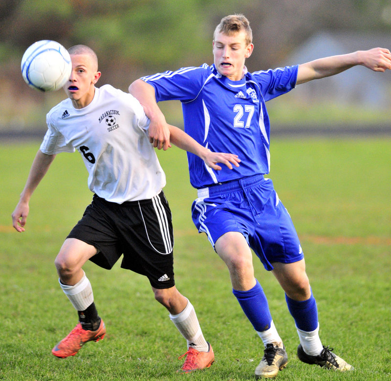 Kody Solmitz, left, of Maranacook, battles with Yarmouth’s Hugh Grygiel during Saturday’s game in Readfield. Falmouth advanced with a win on penalty kicks.