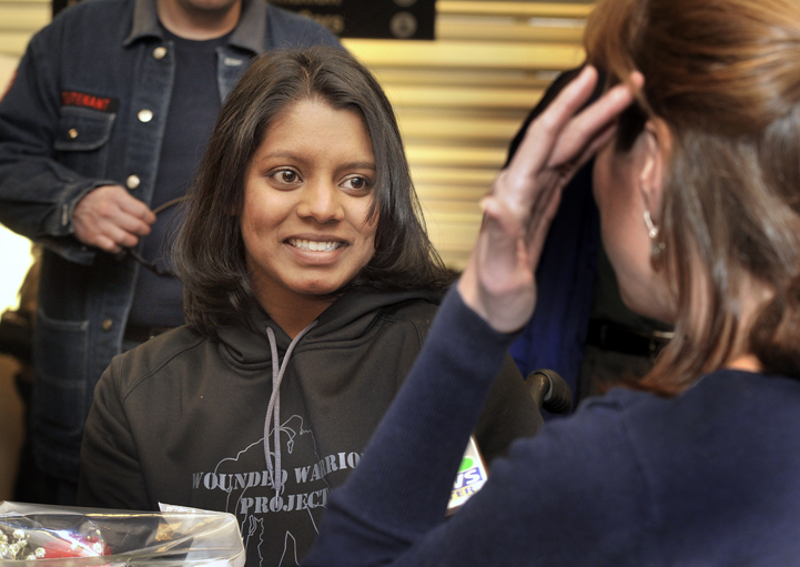 Army Sgt. Helaina Lake, who was severely injured in Afghanistan, returned home to Maine on Tuesday. Lake was met by family, friends and media upon her arrival at the Portland Jetport.