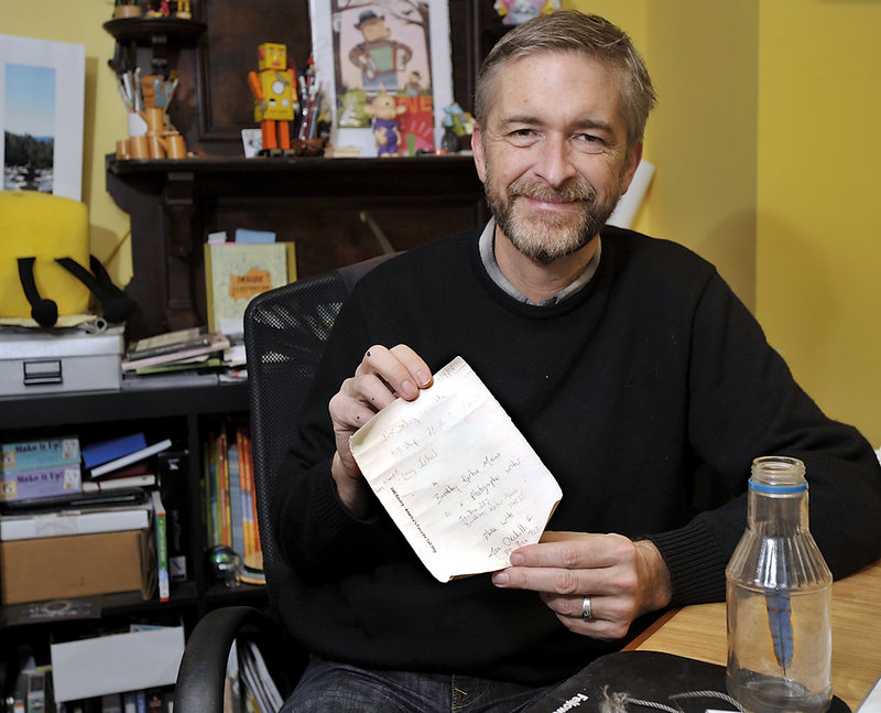 Scott Nash shows the message in a bottle that he found on Peaks Island.