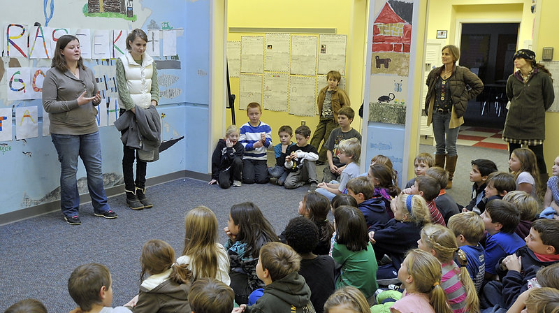 Abigial Smith and Sophie Smith, talk to students Thursday at Mast Landing School about the Freeport-to-Freeport assistance effort. The Freeport High students are collecting cash donations and supplies until Dec. 21.