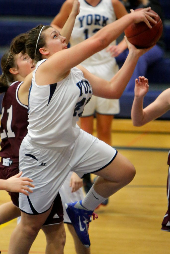 Marquis MacGlashing of York drives to the basket past Greely’s Margaret Hatch. MacGlashing helped spark a pair of 10-0 runs in the second half that enabled the Wildcats to improve to 2-0.