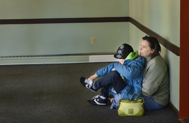 Kellie Keliehor, with her 7-year-old daughter Chloe, listens to her other daughter Brianna, 13, speak at a press conference Wednesday for the Baxter Academy for Technology and Science, a new charter school in Portland.