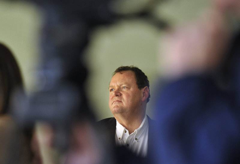 Framed by a TV camera, John Jacques, executive director of the Baxter Academy for Technology and Science, listens in on a press conference Wednesday, Jan. 2, 2012 at the school's 54 York Street location, to announce that they are now accepting application.