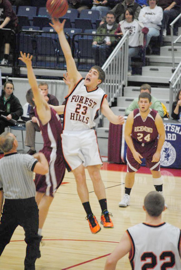 Evan Worster of Forest Hills wins the jump ball during the Tigers' Western D quarterfinal win over Richmond on Saturday.