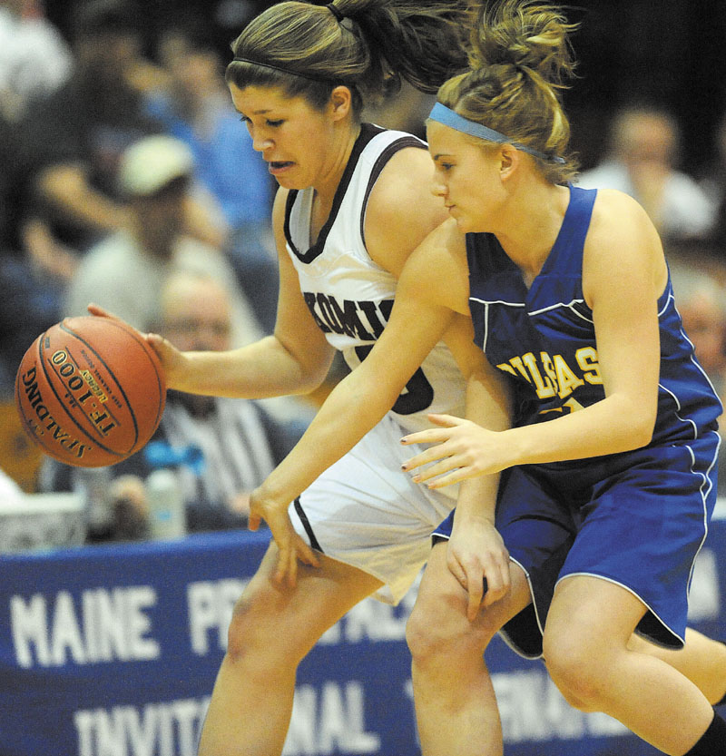 Nokomis High School's Anna Mckenzie, 40, left, battles for the ball with Belfast High School's Katrina Lapham, 2, right, in the first half in the Class B Eastern regional quarterfinals at the Bangor Auditorium Friday. Nokomis defeated Belfast 59-49.