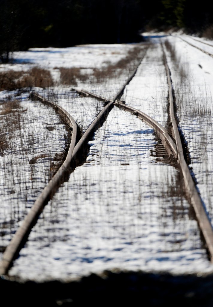 These overgrown railroad tracks are in Bowdoinham. Plans to expand passenger service to Augusta are on hold.