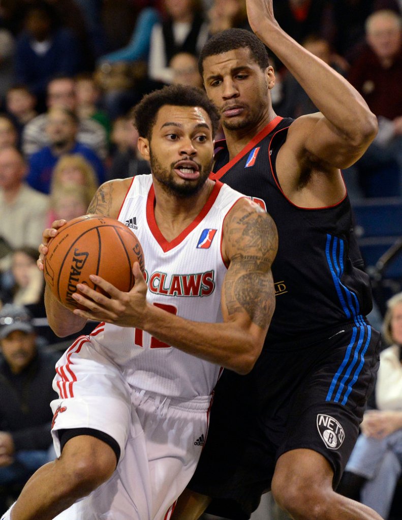 Red Claws guard Xavier Silas drives past Springfield’s Carleton Scott during Maine’s 104-100 win Sunday.