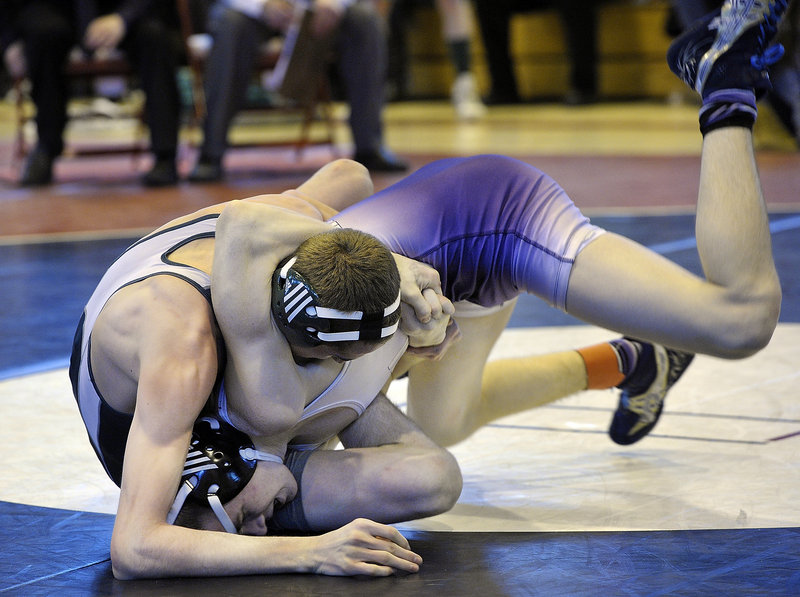 Tyler Davidson, right, of Marshwood rolls out of a hold by John Gillar of Bonny Eagle into a winning position in the semifinals of the 120-pound weight class at the Class A state wrestling meet Saturday in Sanford. Davidson went on to win the fourth state championship of his career, and Marshwood also won the team title.