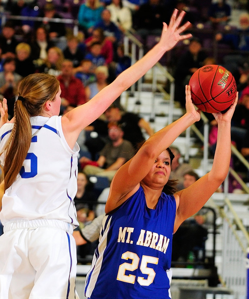 Annie Dexter of Mt. Abram looks for a teammate while keeping the ball from Bronte Elias of Madison in Madison's 50-42 victory in a Western Class C quarterfinal.