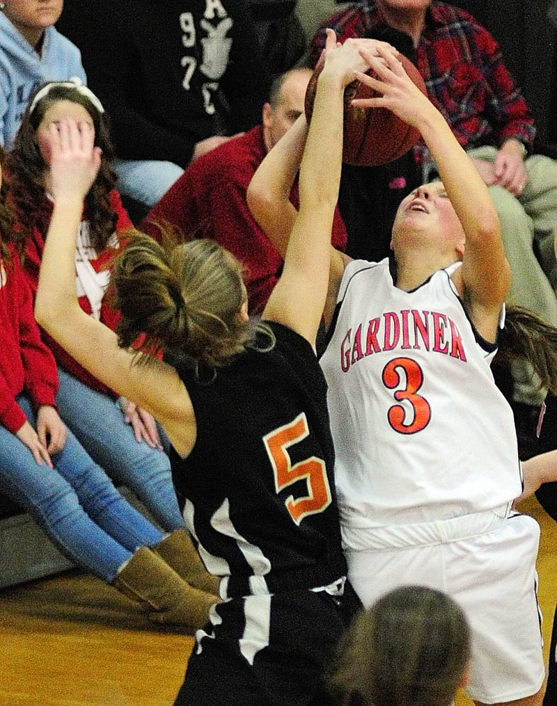 BLOCKED: Winslow's Erica Bertolaccini, left, blocks a shot by Gardiner's Kelsey Moody during a game Tuesday in John A. Bragoli Memorial Gym at Gardiner Area High School.