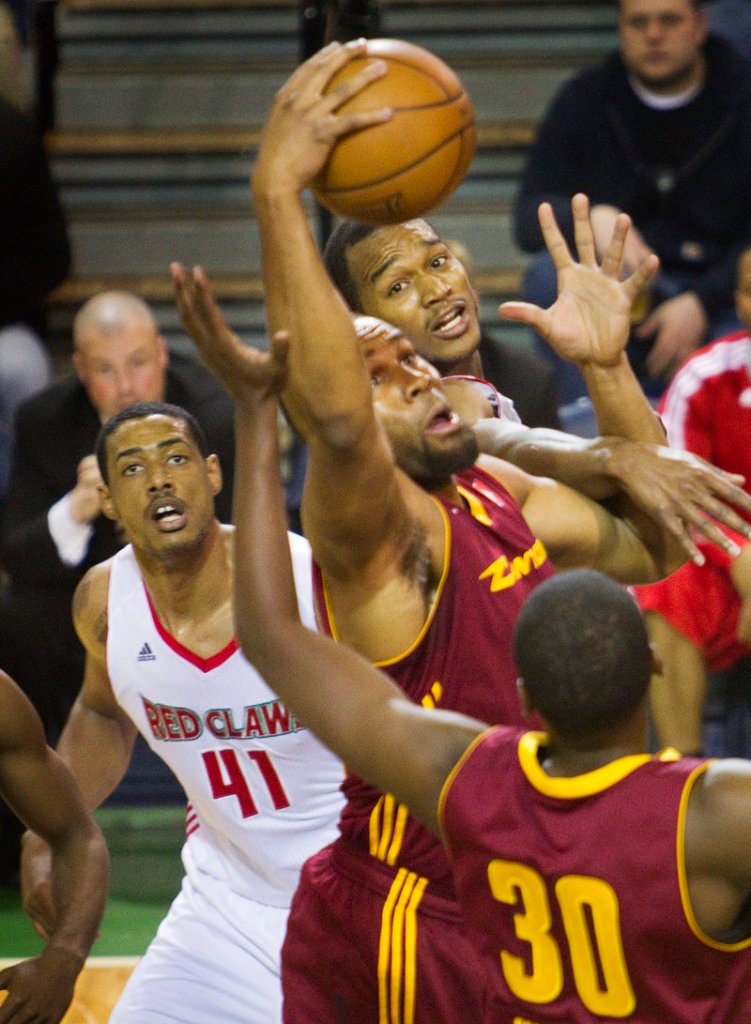 Arinze Onuaka of Canton hauls in a rebound ahead of Fab Melo of the Red Claws. Onuaka and Melo were college teammates at Syracuse.