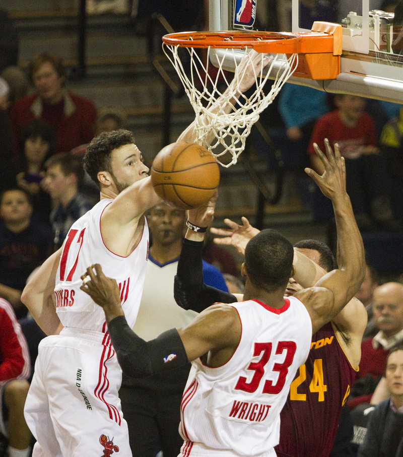 Jeremiah Rivers of the Maine Red Claws lays the ball in Friday night in front of teammate Chris Wright and Antoine Agudio of the Canton Charge. Canton moved three games ahead of Maine with a 91-87 victory at the Expo.