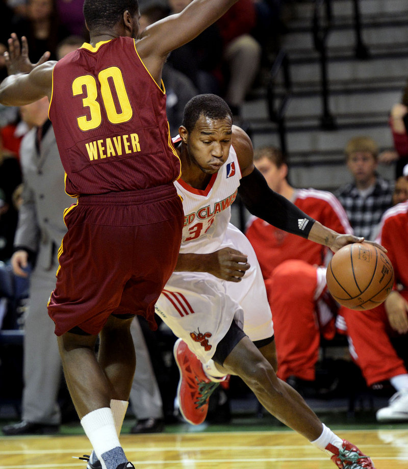 Chris Wright of the Red Claws drives against Canton’s Kyle Weaver. Wright finished with a team-high 20 points, but Canton had seven players in double-figures and earned a 108-83 victory.