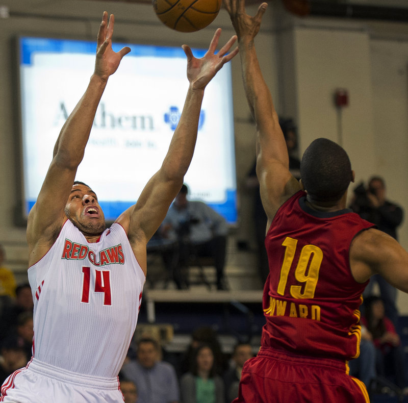 Maine’s Mark Tyndale reaches for a pass while Fort Wayne’s Ron Howard defends during first-half action of Thursday’s game at the Expo Center, won by the Mad Ants.