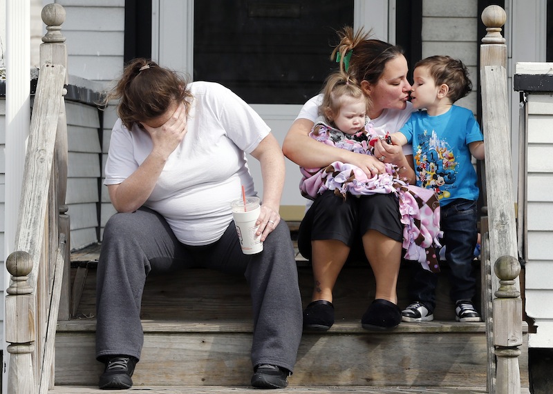 Neighbors sit outside the house of Krystle Campbell's parents in Medford, Mass.,Tuesday, April 16, 2013. Campbell was killed in Monday's explosions at the finish line of the Boston Marathon. (AP Photo/Michael Dwyer)